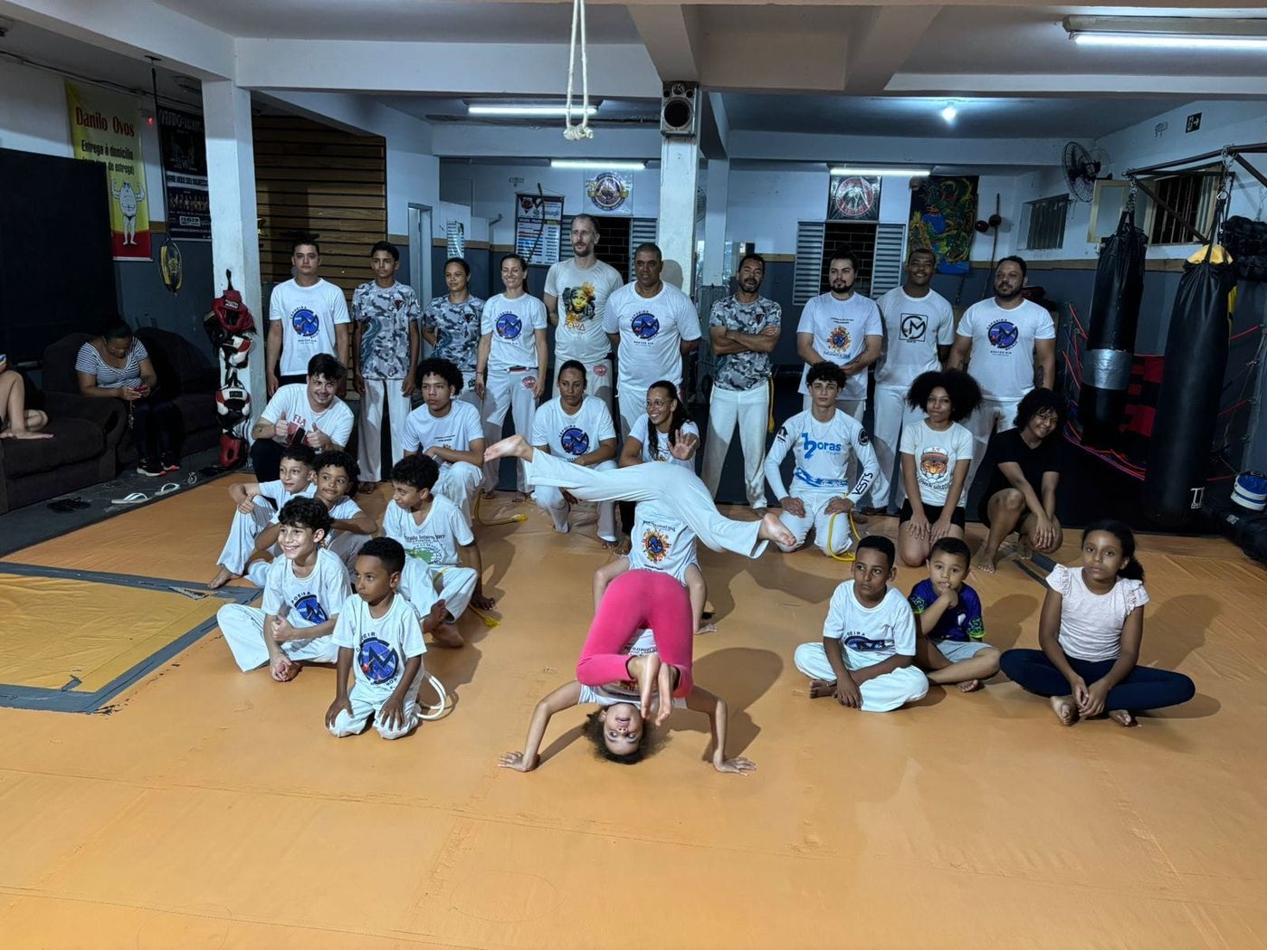 Turma do CT Furacão reunida, com uma aluna fazendo parada de mão no centro